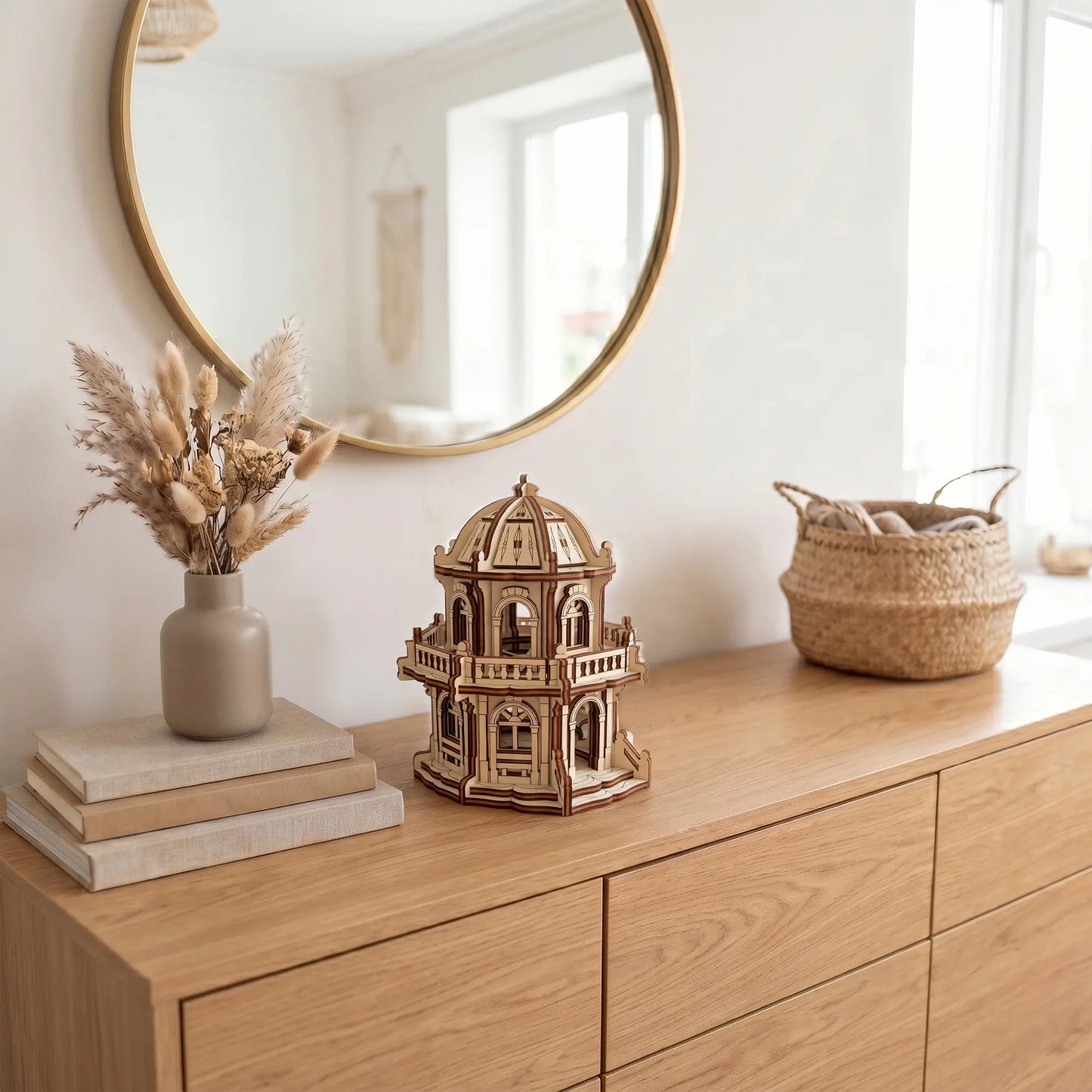 Miniature dome temple made of laser cut plywood displayed on a modern wooden dresser beneath a round wall mirror.