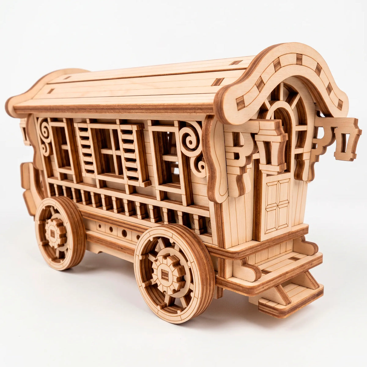 Back angle view of a finished unpainted laser-cut plywood fairy wagon model highlighting its detailed door and entry steps