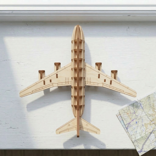 Wooden laser cut airplane model on a white surface with a map