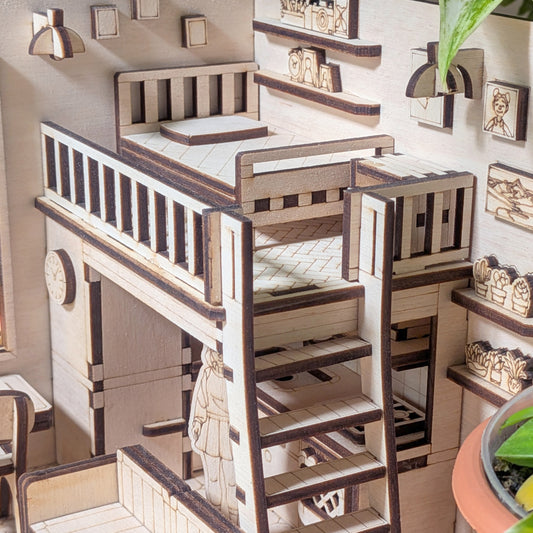 Miniature wooden loft bed with ladder and balcony railings in a dollhouse-style room. Detailed shelves, wall art, and plants. Designed as a laser cut wooden diorama template