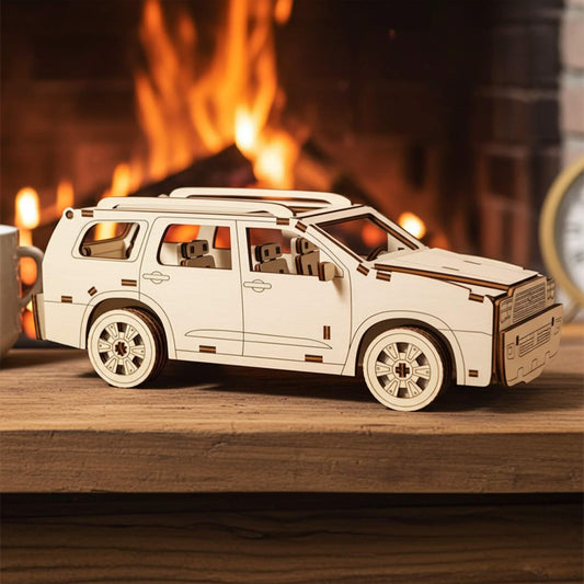 Laser cut wooden plywood model in profile on a rustic mantle. Detailed 3D plywood assembly showing roof racks, multi-spoke wheels, and interior seats. Cozy indoor background with a warm fireplace and blurred holiday lights