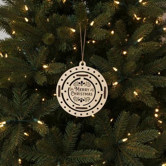 Interactive laser cut Christmas tree toy Xmas featuring a rotating holly wreath design on a round hanging ornament engraved with festive wishes, set against a softly lit Christmas tree background.