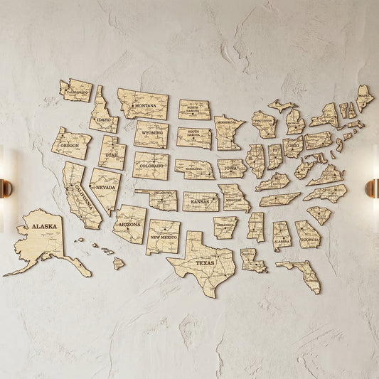 Exploded view of a laser cut plywood USA map with individual state pieces spaced apart on a wall. Each piece shows detailed engraved road maps. Highlights the unique grain of the wood and the multi-piece puzzle design of the wall art.