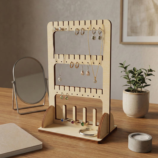 Natural light wood laser cut jewelry organizer featuring a framed mirror panel, dedicated earring rows, necklace hangers, and bracelet holders, on a cozy vanity table setting.