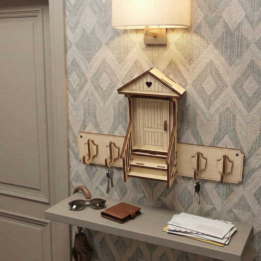 Laser cut wooden keyholder shaped like a charming front door house with heart detail, featuring multiple hooks for keys and a small shelf, on a light hallway wall background.