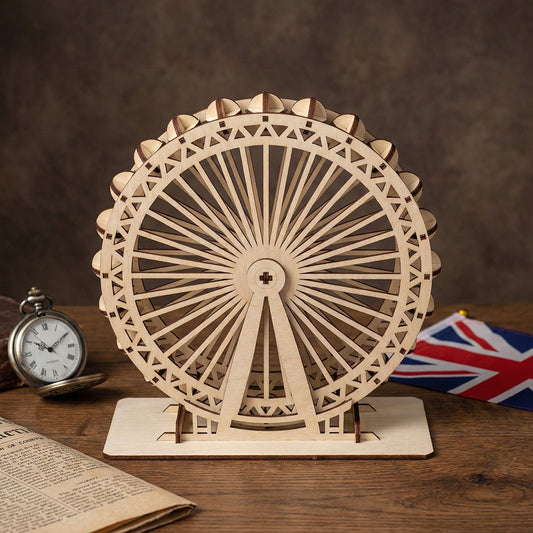 Front-facing view of a London Eye souvenir made from laser cut plywood. The intricate wooden spokes and passenger capsules are highly detailed. Set on a wooden table with a vintage newspaper and pocket watch, highlighting the craft's texture.