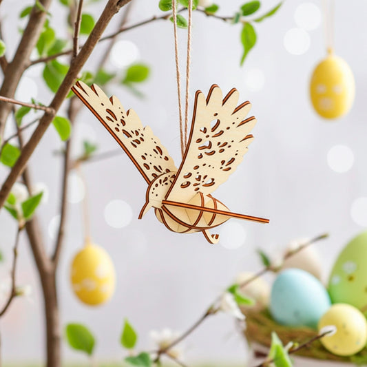 Laser-cut plywood wooden bird ornament hanging on a tree branch with soft spring leaves and pastel Easter eggs in the background