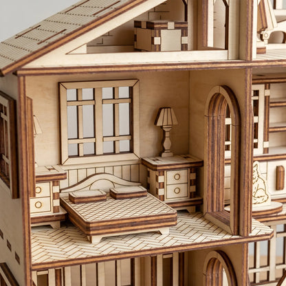 Wooden dollhouse with detailed interior including a bed, nightstands, and lamps.