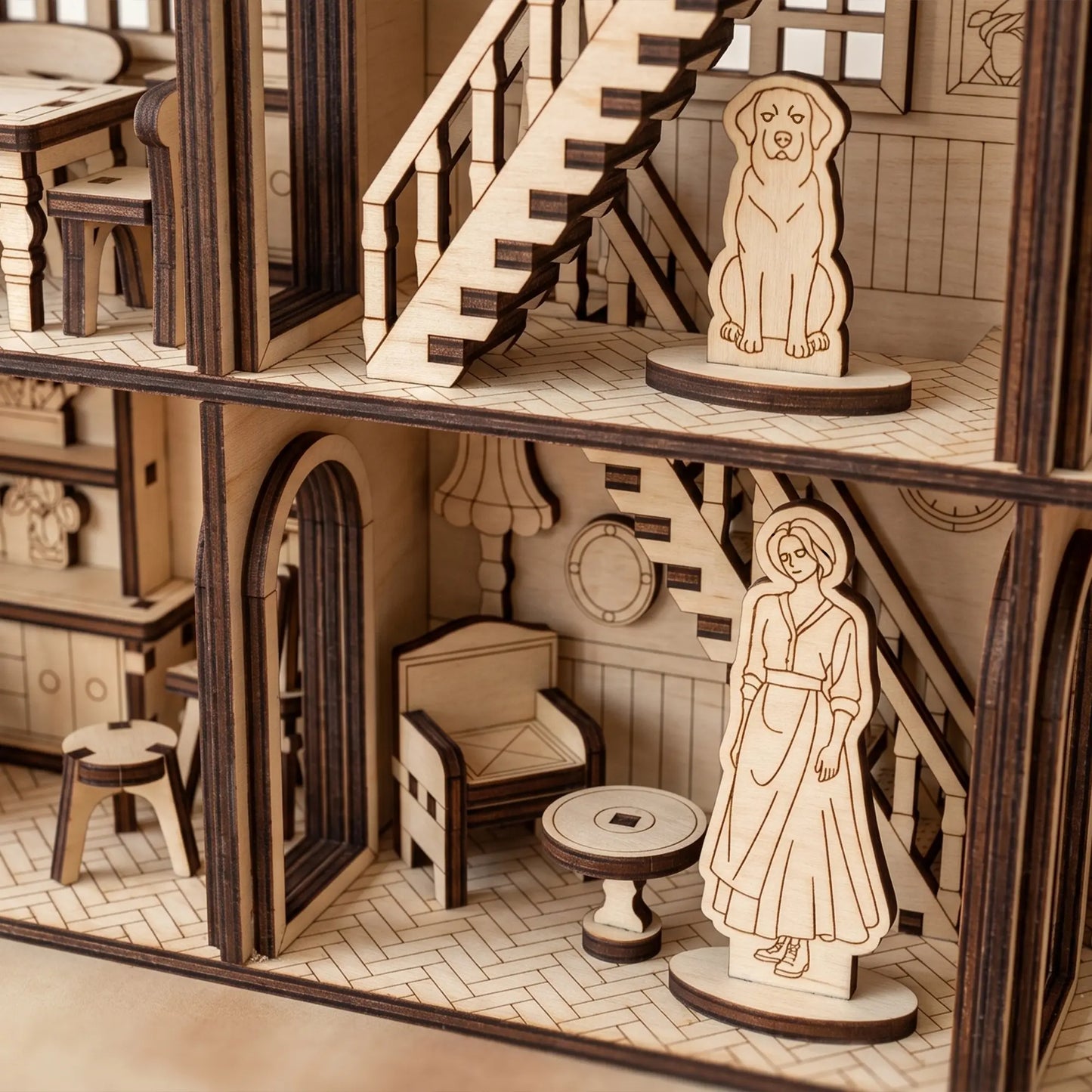Wooden dollhouse with detailed furniture and figures on a neutral background
