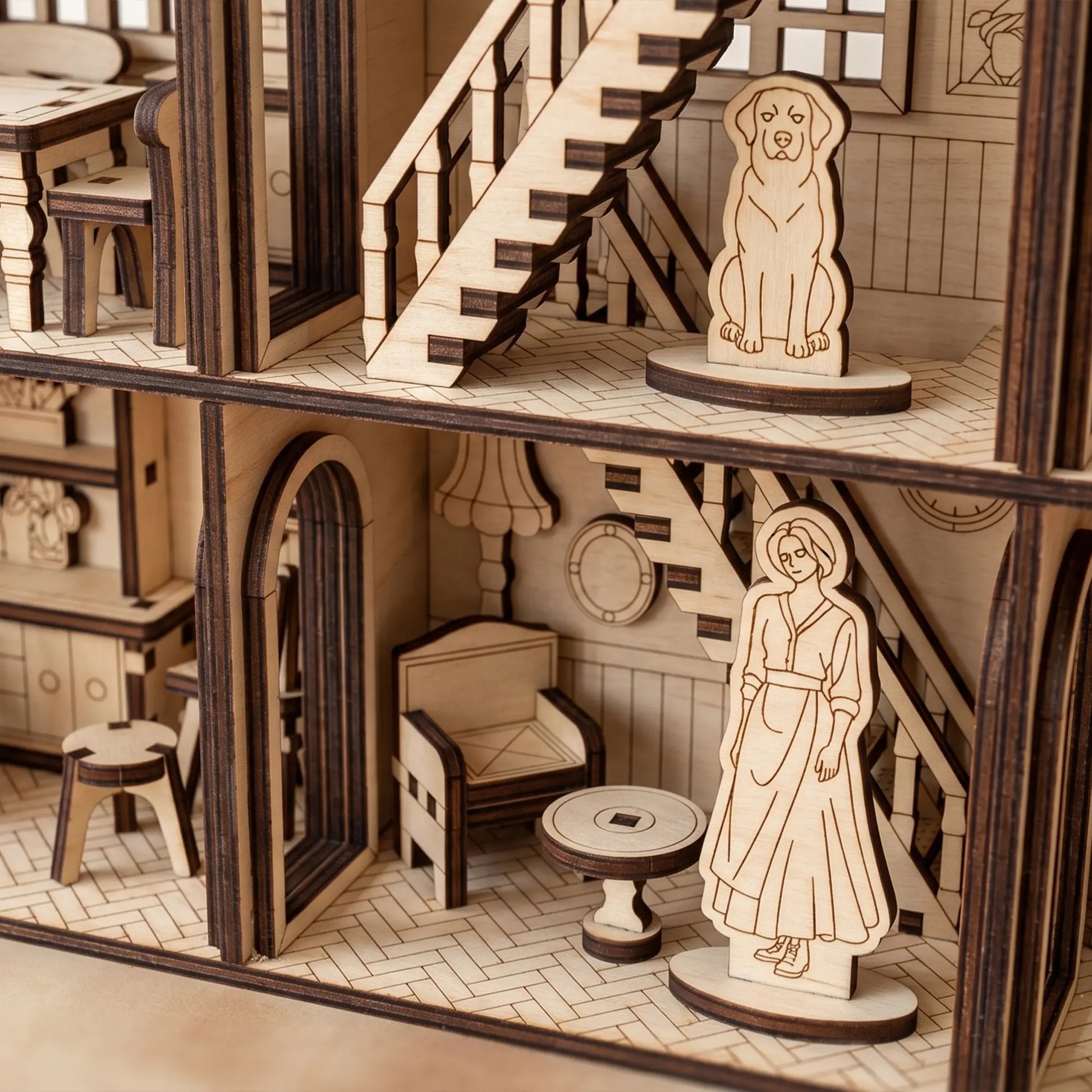 Wooden dollhouse with detailed furniture and figures on a neutral background