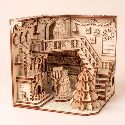 Santa's workshop book nook in laser cut plywood with Christmas tree, fireplace, and staircase. White background.