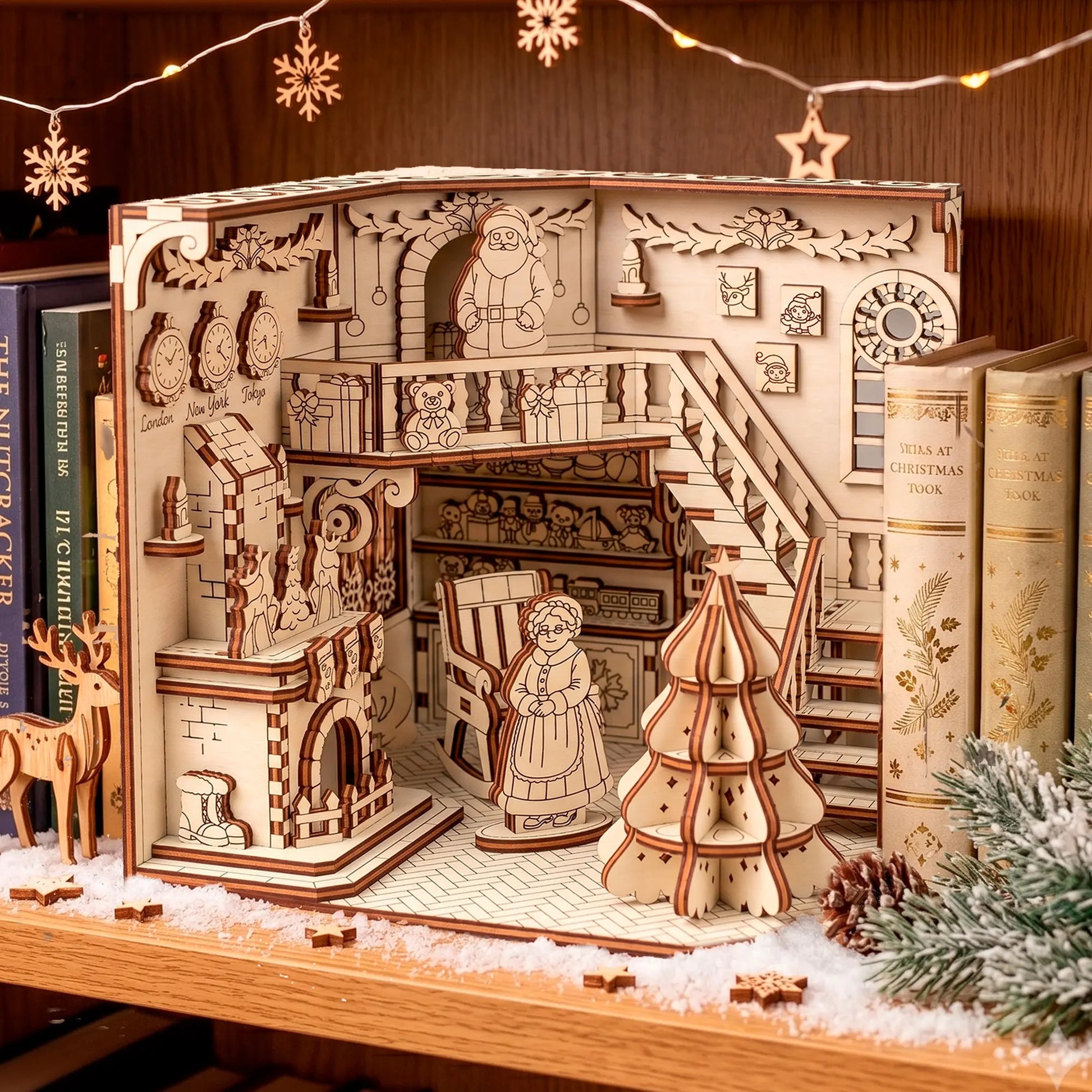 laser cut plywood book nook of santa workshop, featuring a tiny fireplace, toy chest, and a detailed window.