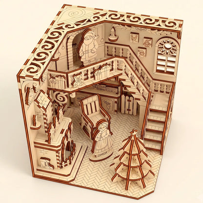 High-angle top view of a laser cut plywood Santa workshop showing the detailed ceiling trim, floor, and miniature layout.