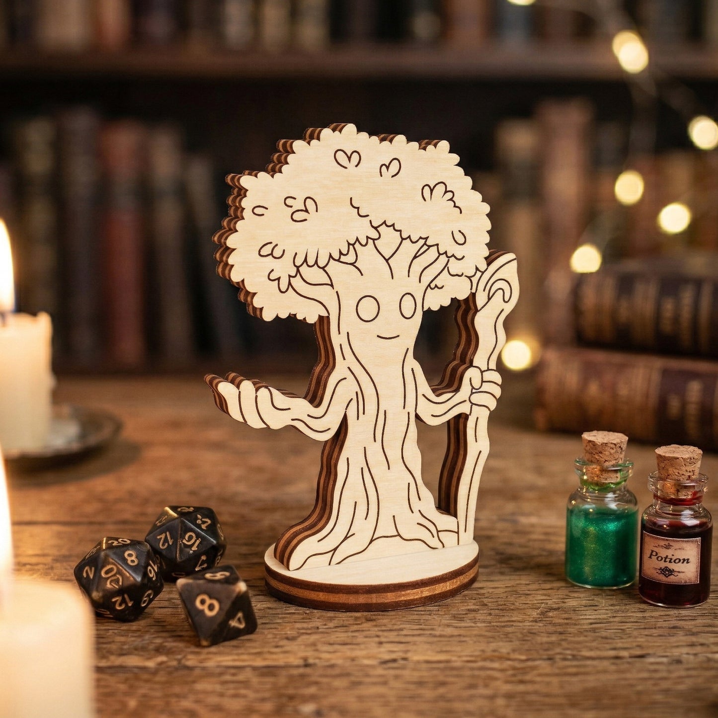 A single 3D forest mage tabletop miniature made from layered laser-cut wood. The character is a sentient tree-man holding a staff. Posed on a wooden desk next to metal polyhedral gaming dice and small glass bottles with red and green potion liquids.