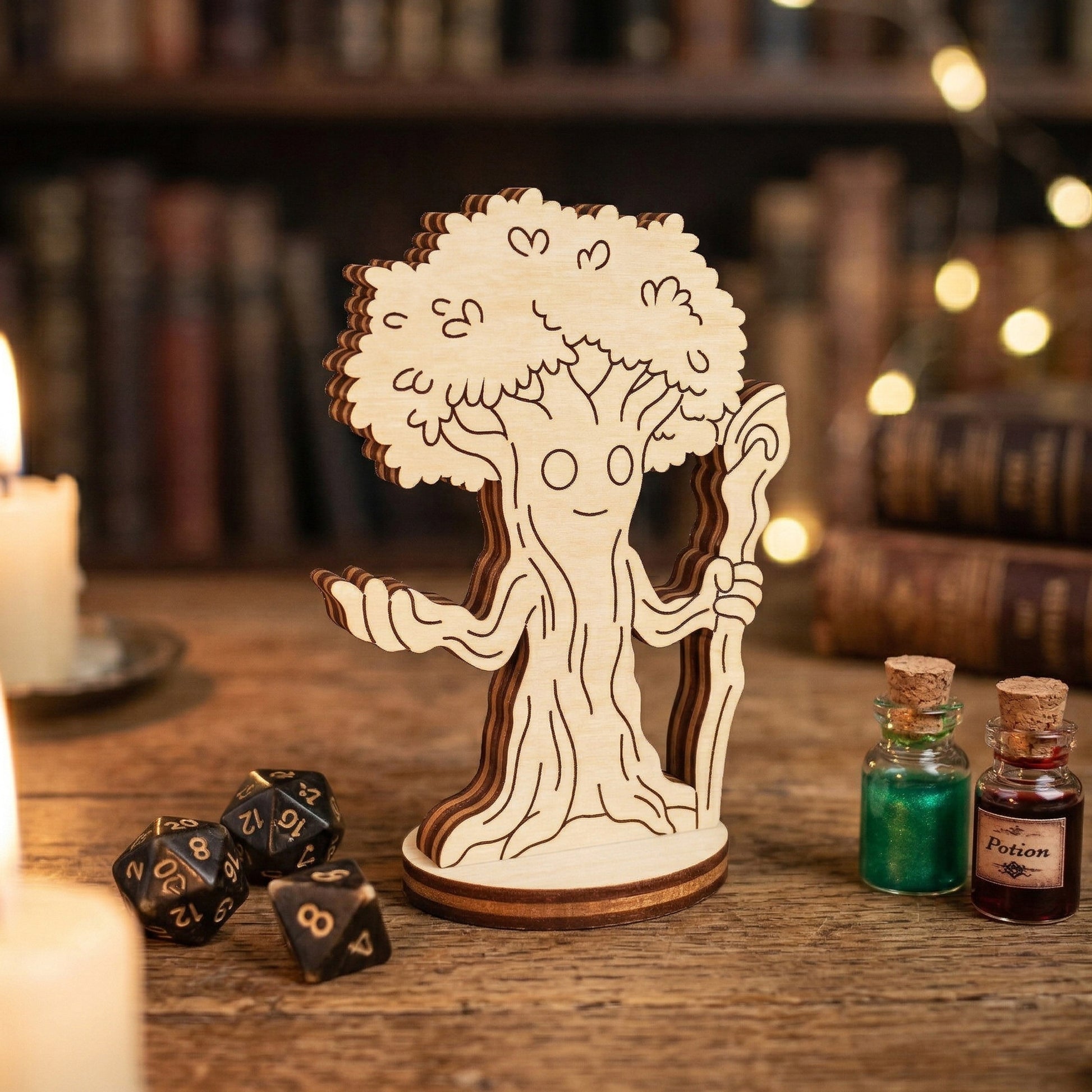 A single 3D forest mage tabletop miniature made from layered laser-cut wood. The character is a sentient tree-man holding a staff. Posed on a wooden desk next to metal polyhedral gaming dice and small glass bottles with red and green potion liquids.