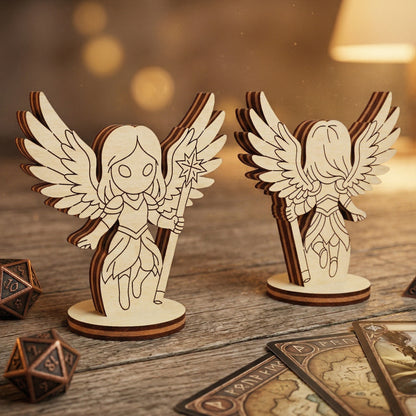 Front and back views of a 3D celestial angel figurine handcrafted from layered laser-cut plywood. The chibi-style character features intricately detailed wings and a star-topped staff, mounted on a circular base. Displayed in a tabletop gaming setting on a rustic wooden table with metal polyhedral dice and fantasy cards.