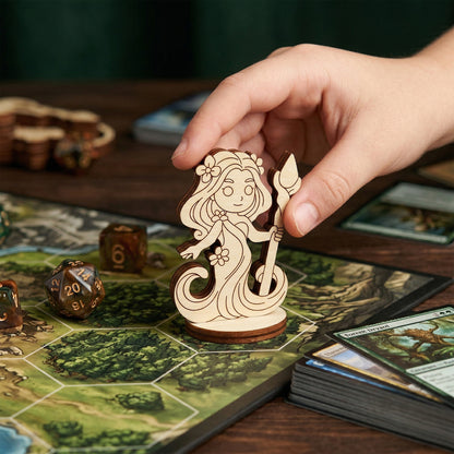 A player's hand moving a laser-cut wooden forest dryad miniature across a hexagonal tabletop game map. The scene includes various RPG elements like brown marbled dice and forest-themed ability cards, showcasing the figurine's scale and role in a tabletop roleplaying game session.