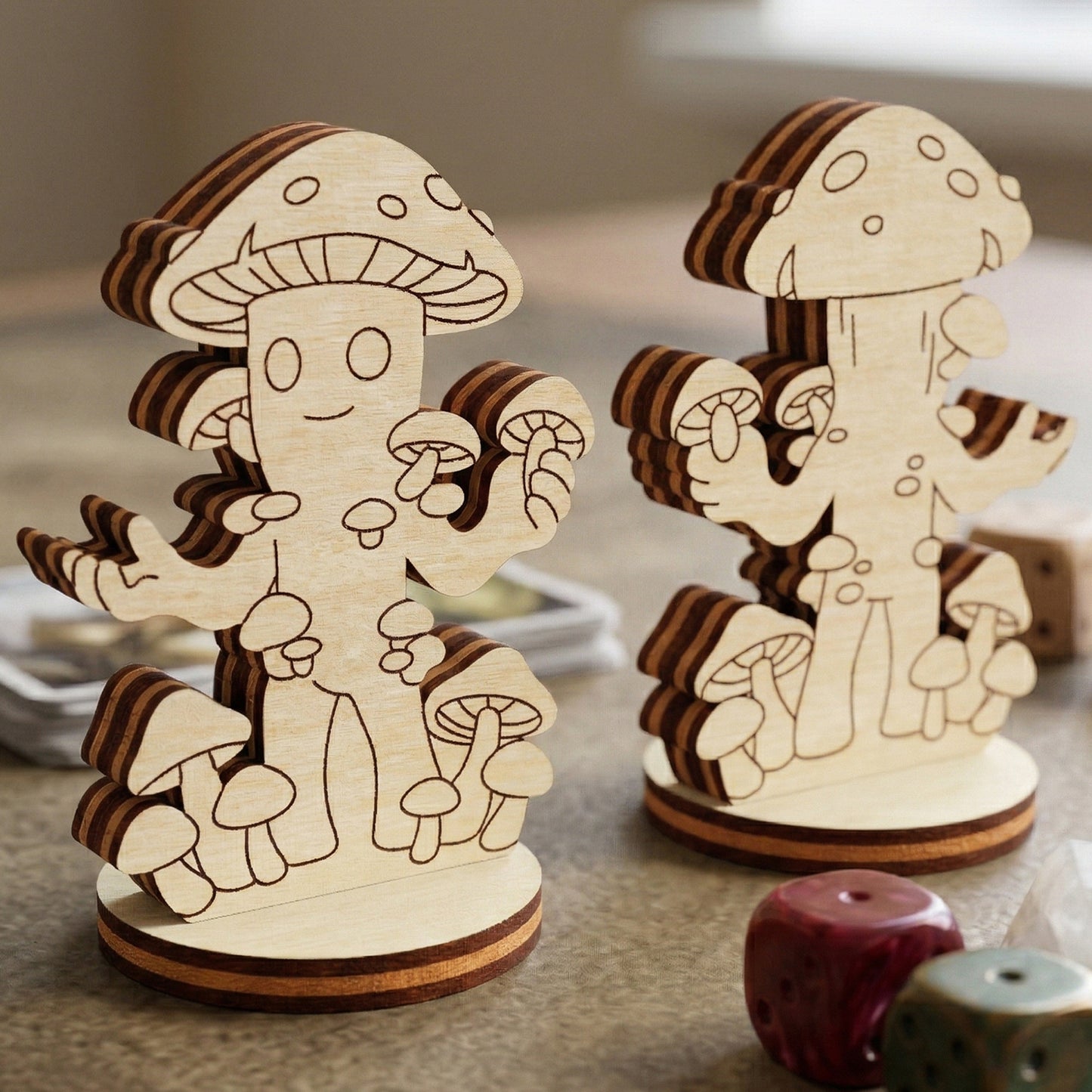 Laser cut plywood mushroom folk figurine with engraved details, standing on a game mat with colorful dice and game cards.