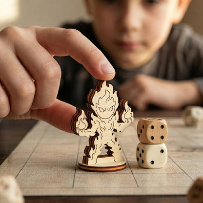 A hand holds a laser cut plywood fire elemental figurine on a grid map next to dice, showing its scale for tabletop gaming.