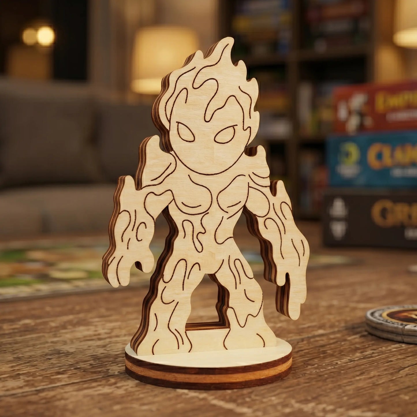 Close-up of a laser cut plywood lava elemental figurine with engraved drip patterns. Standing on a wooden table with game boxes.
