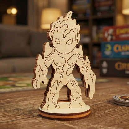 Close-up of a laser cut plywood lava elemental figurine with engraved drip patterns. Standing on a wooden table with game boxes.