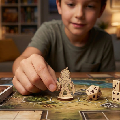 A boy holds a lava elemental figurine made of laser cut plywood over a hexagonal board game map to show scale during a session.