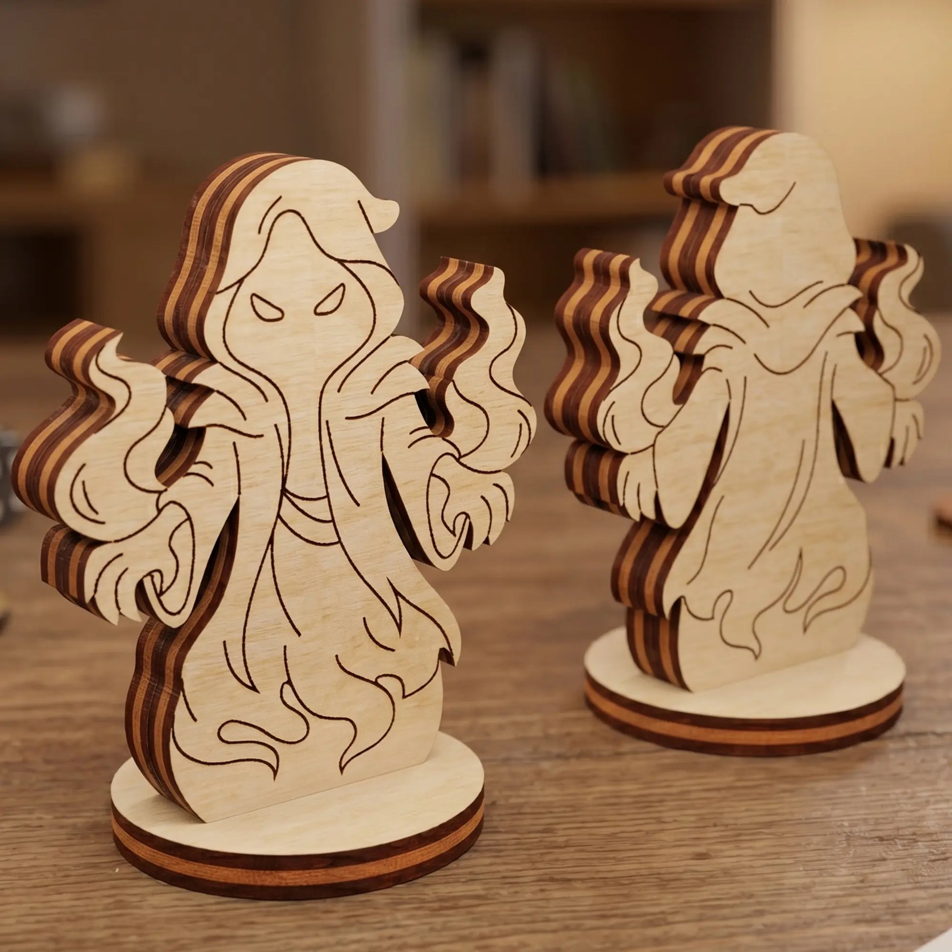 Front and back view of a shadow mage figurine made of laser cut plywood, standing on a wooden table with game pieces nearby.
