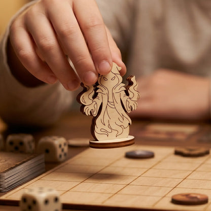 Close-up of a hand holding a shadow mage figurine made of laser cut plywood above a game board, showing the wood grain and texture.