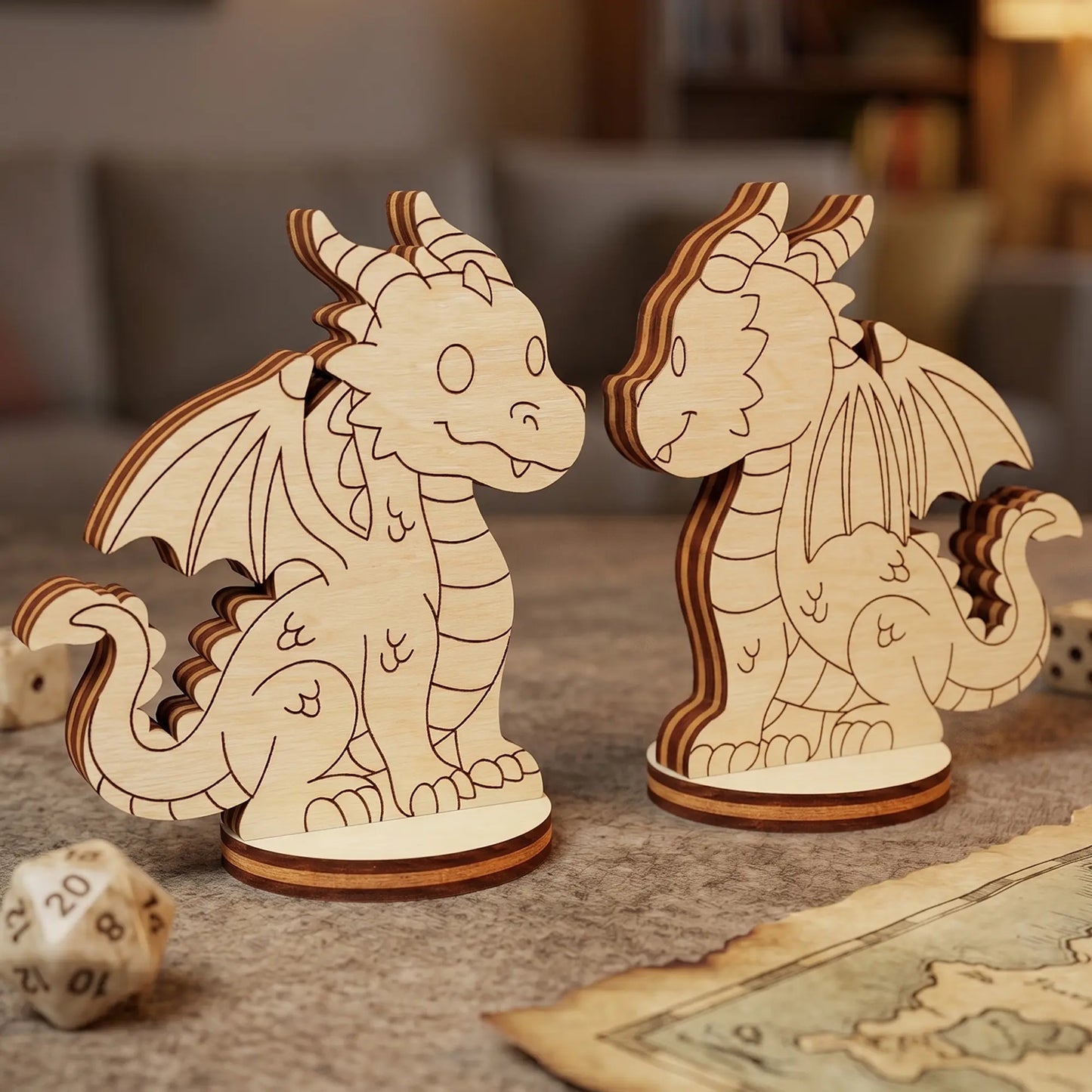 Front and back view of a cute dragon made of laser cut plywood. Displayed on a table with D&D dice and a paper fantasy world map.