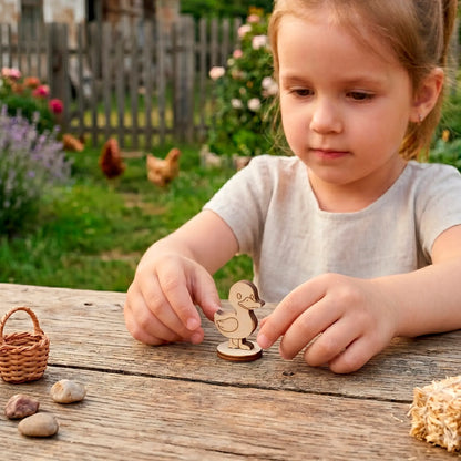 Little girl playing with a small laser cut plywood cute duck toy at a rustic table in the backyard with live chickens.