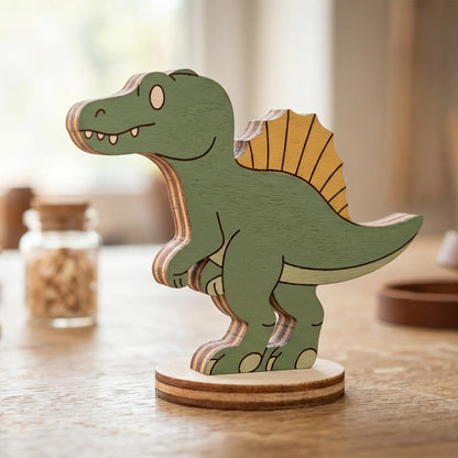 A single laser cut plywood spinosaurus dinosaur toy painted green and orange, standing on a wooden table surface.