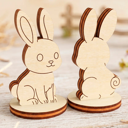 Two laser cut plywood rabbit figurines on round stands shown from the front and back, standing on a light wooden table.