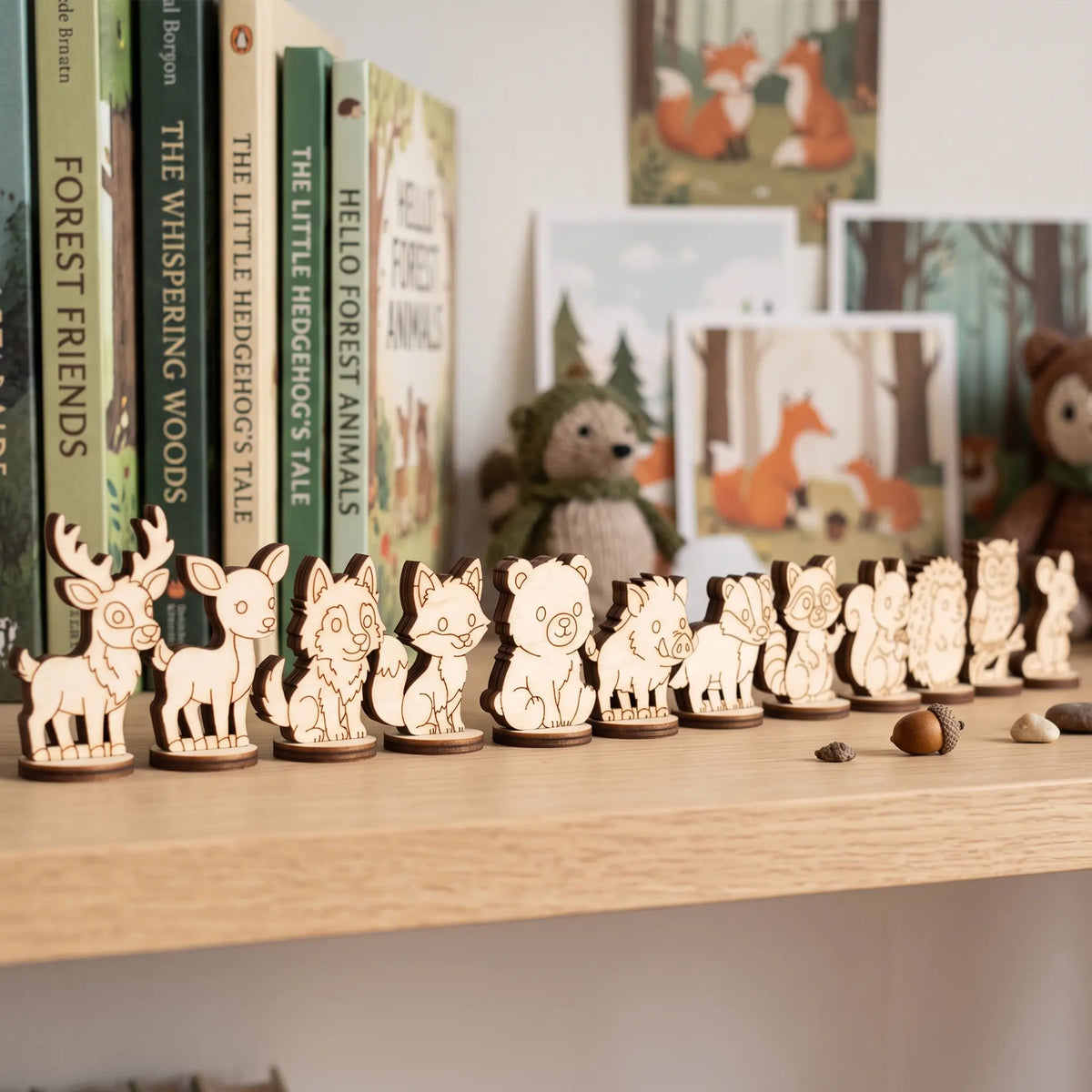 Lineup of 12 laser cut plywood forest animal standing figurines displayed on a nursery bookshelf near storybooks.