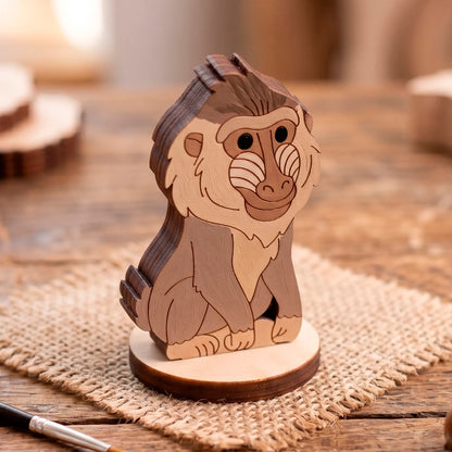 Close-up of a painted laser-cut plywood baboon animal figure standing on wood.