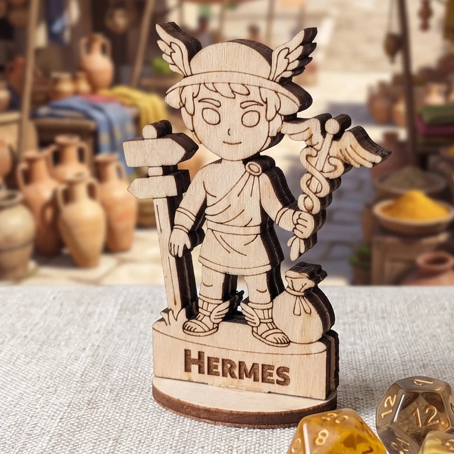 Macro shot of laser cut plywood Hermes miniature on a linen surface with blue polyhedral RPG dice for tabletop game scale