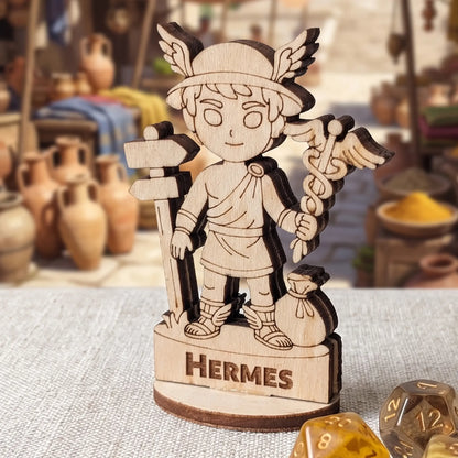 Macro shot of laser cut plywood Hermes miniature on a linen surface with blue polyhedral RPG dice for tabletop game scale
