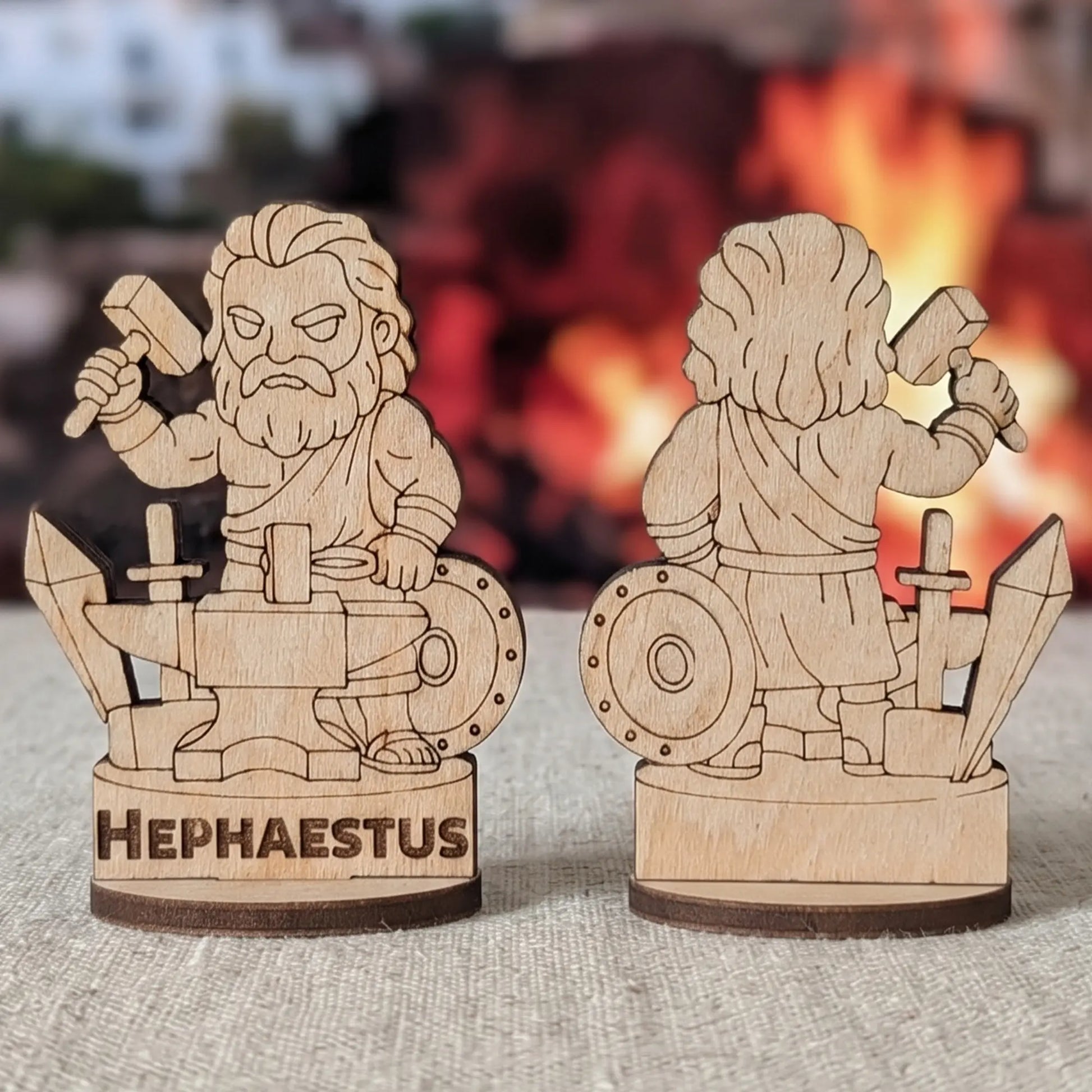 Front and back views of a laser cut plywood Hephaestus figurine with hammer and anvil against blurred ancient ruins
