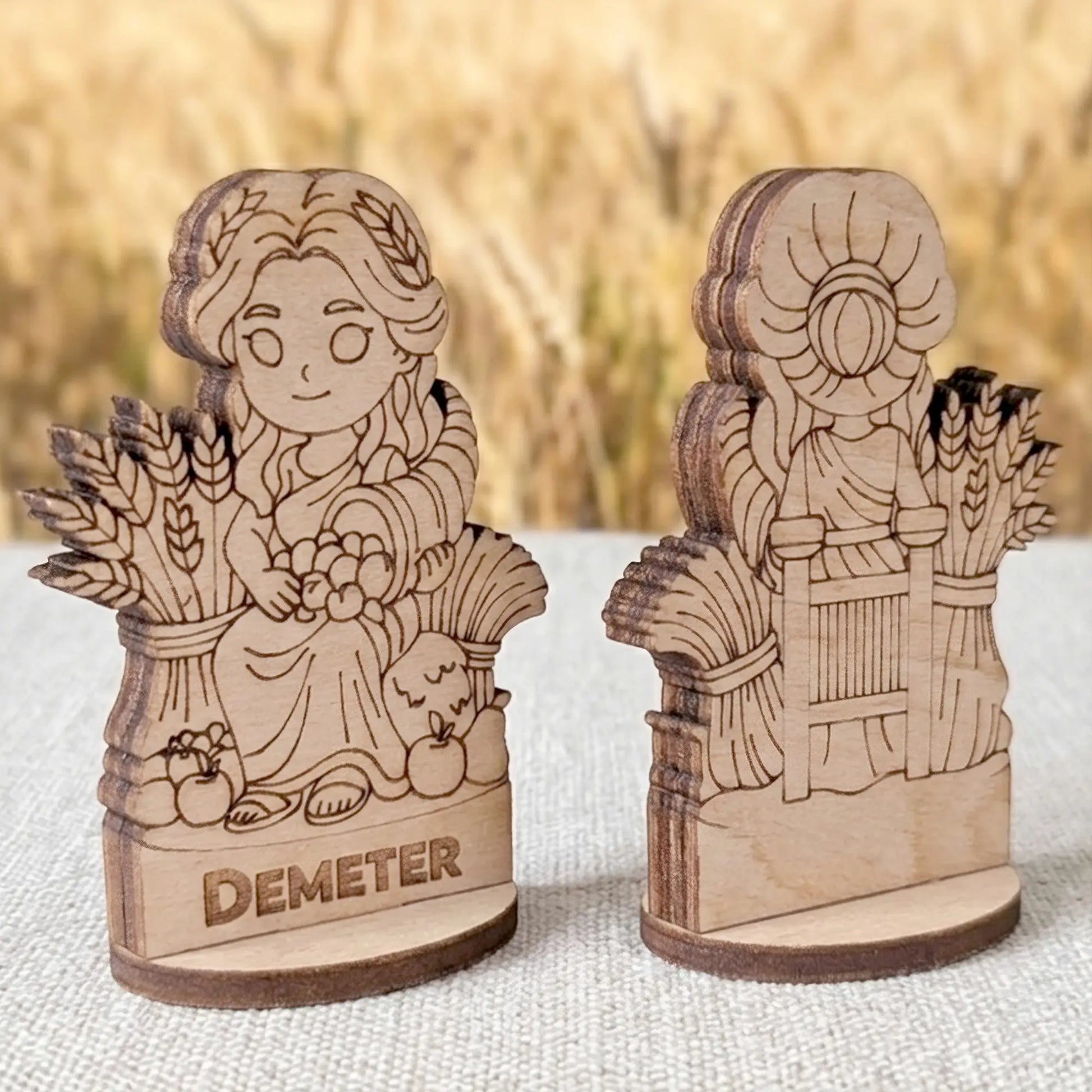 Angled view of a laser cut plywood Demeter figurine showing the layered wood edges and detailed back engraving of wheat bundles