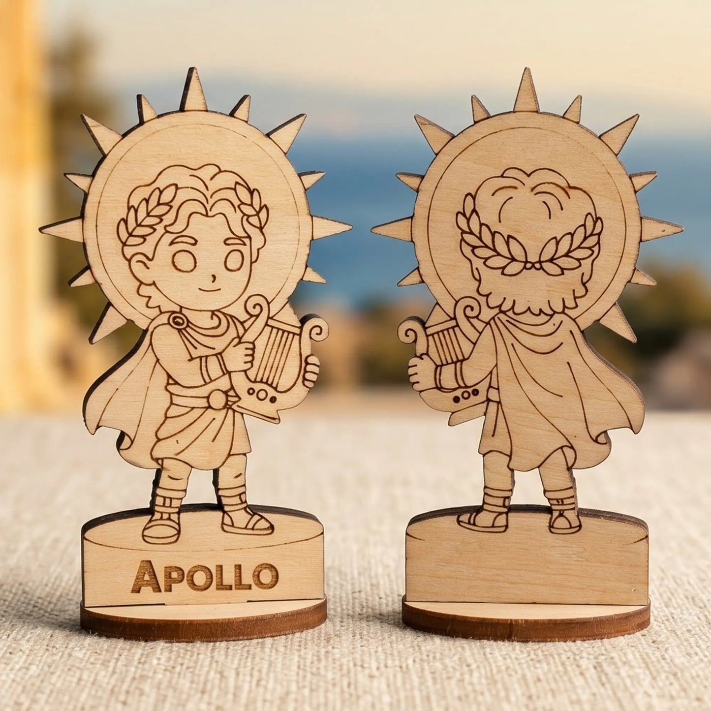 Front and back views of a laser cut plywood Apollo miniature with a lyre and bow against sunlit blurred Greek ruins.