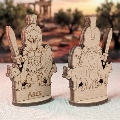 Angled side views of a laser cut plywood Ares figurine showing dark burnt edges and detailed engraved character features