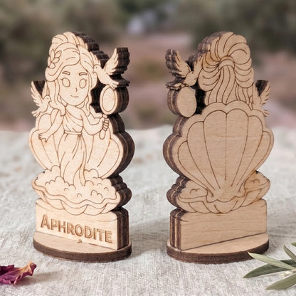 Angled side view of a laser cut plywood Aphrodite figurine showing dark burnt wood edges and detailed layered texture