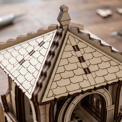 Macro close-up view showing the tiled roof panels and ridges of a fantasy tower model built with laser cut plywood.
