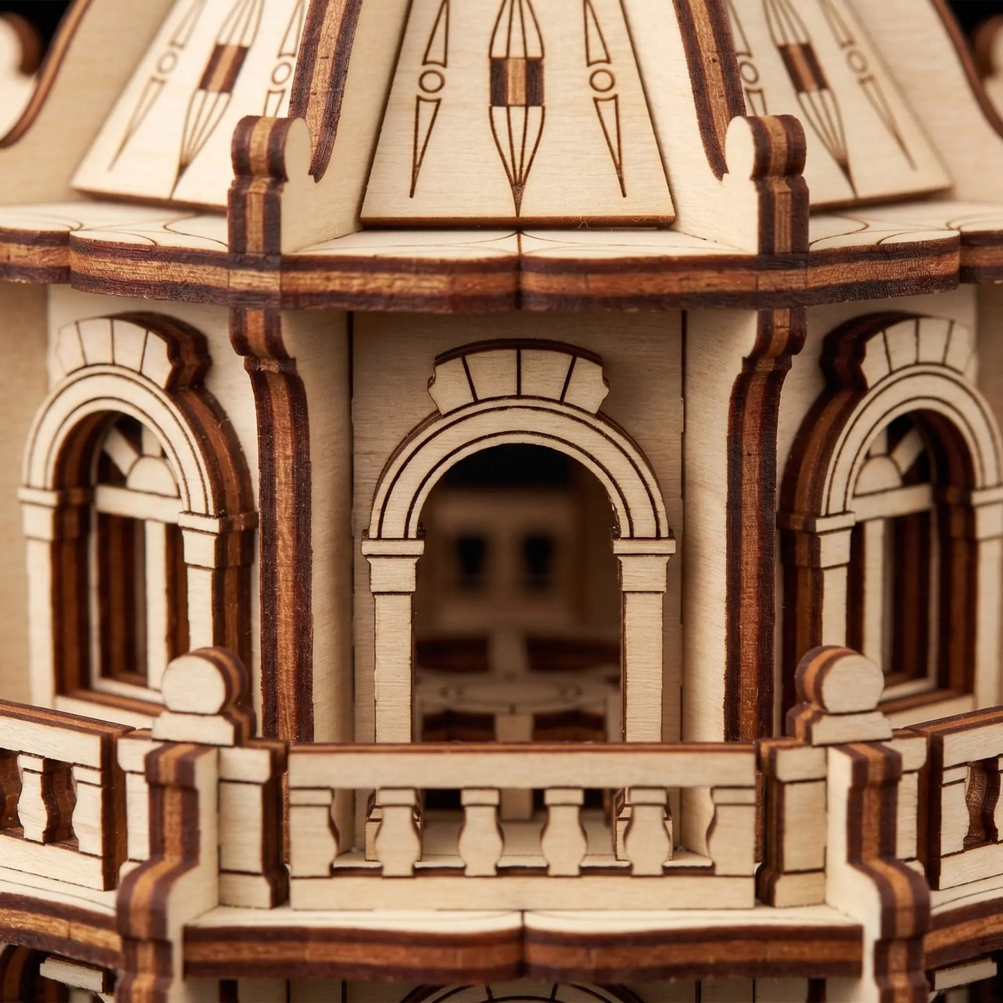 Extreme close-up view showing the arched windows and tiny railings of a laser cut plywood building craft model.