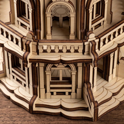 Macro close-up of tiered miniature balconies and archways on a palace craft model made from layered laser cut plywood.