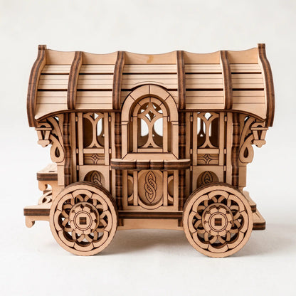 Laser-cut plywood vintage caravan model kit, side profile showing intricate window patterns and detailed wheels.