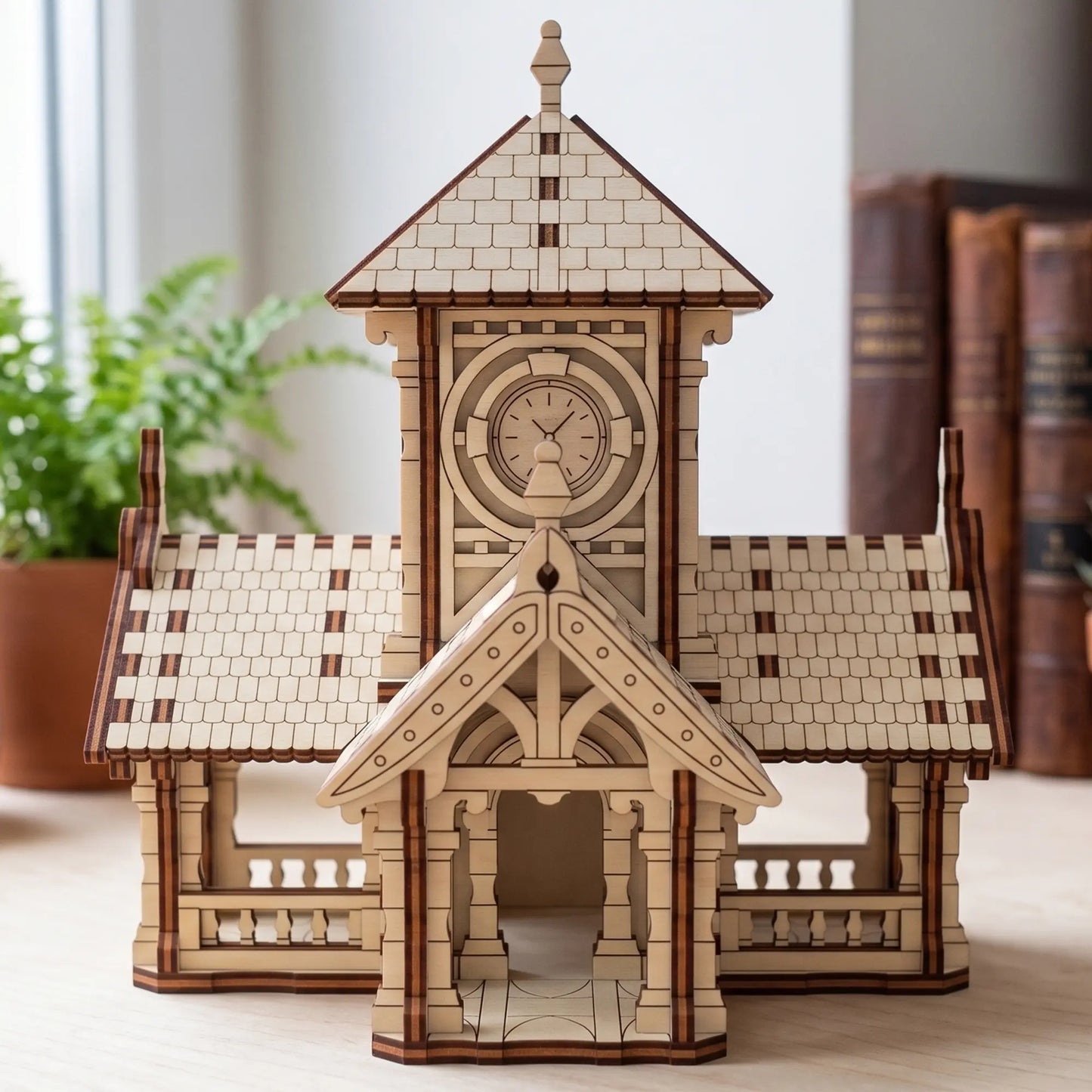 Front view of a miniature laser cut train station with clock tower house model assembled