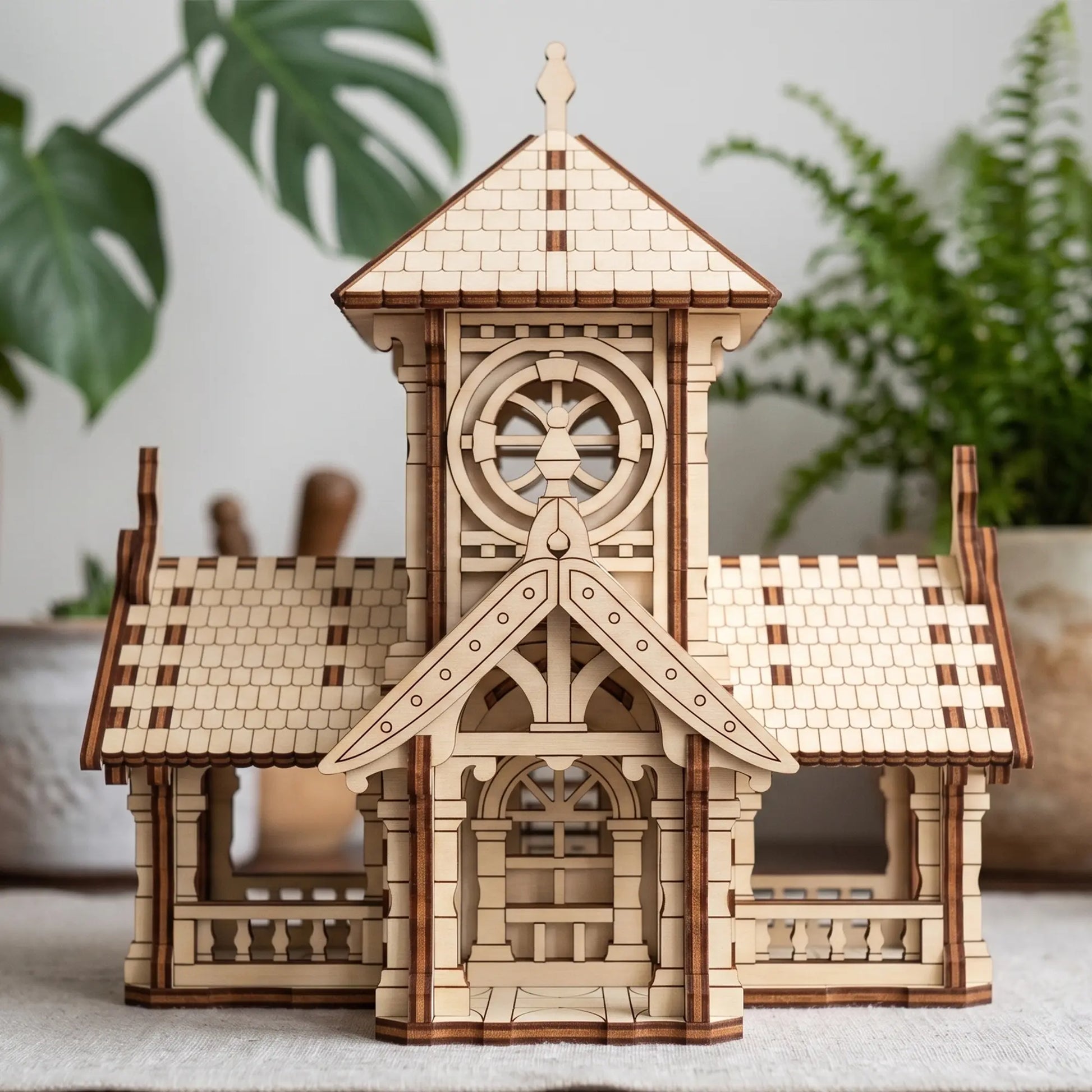 Symmetrical front view of a miniature wooden town hall clock tower toy constructed with laser cut plywood lines.