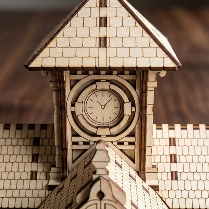 Macro close-up showing the engraved dial hands and face on a miniature clock tower made from laser cut plywood.