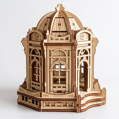 Front angle view of 3D laser cut plywood fairy rotunda gazebo showing entry stairs and carved dome on plain white backdrop.