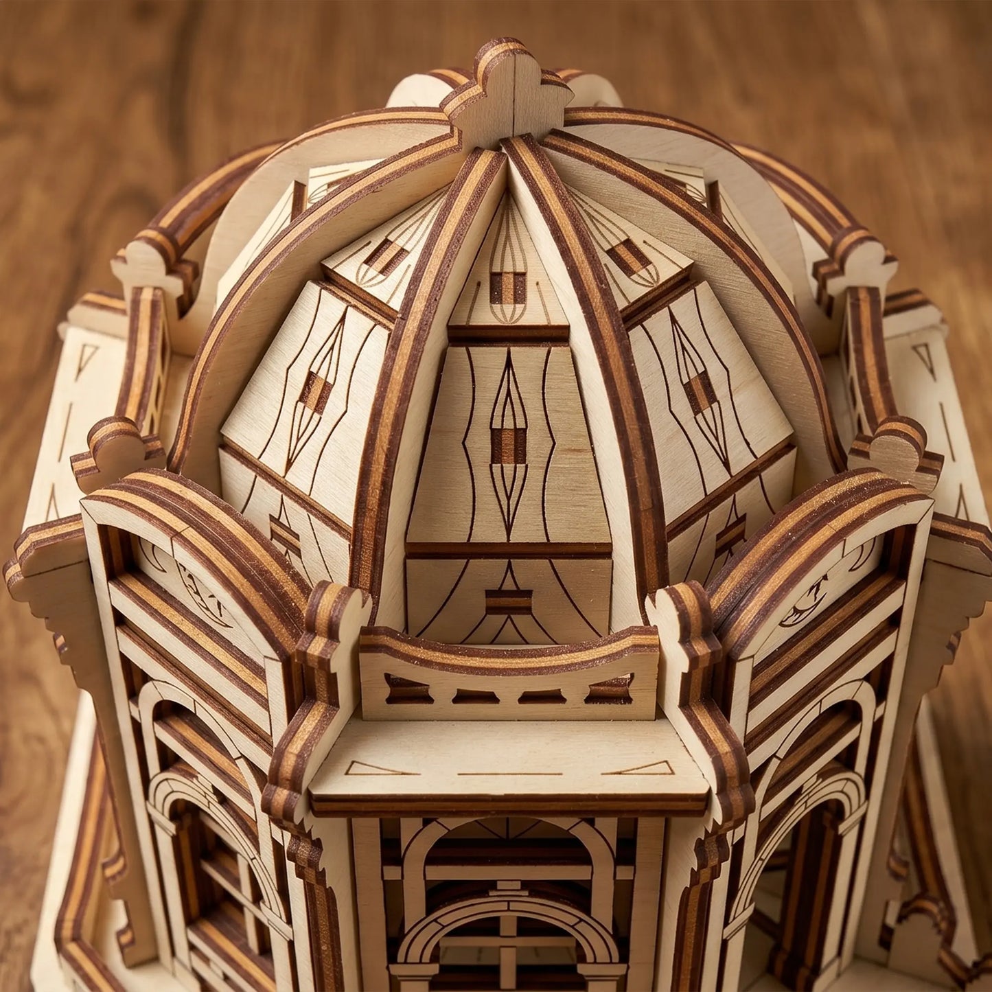 Top-down macro view of the intricate paneled dome structure on a fantasy house model made of laser cut plywood.